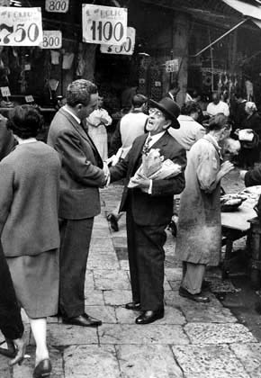Palermo. Two gentlemen talking at the Vucciria market, 1960